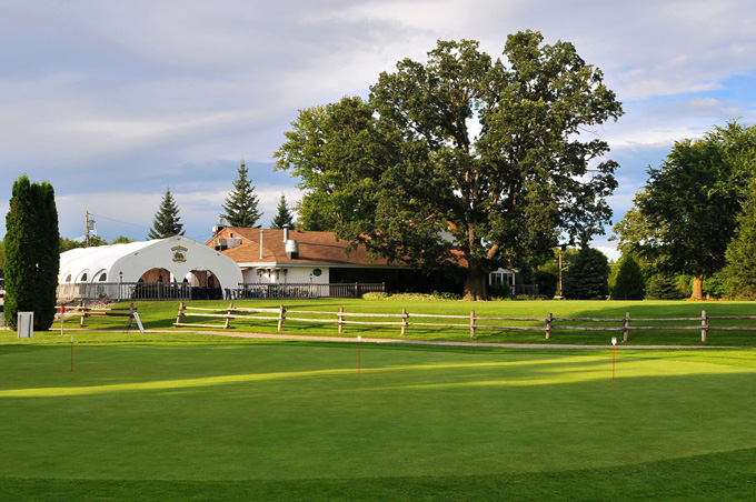 green with clubhouse in background